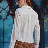 Back view of woman wearing ivory long sleeve blouse showing shawl collar, back yoke, center pleat and textured stripe fabric