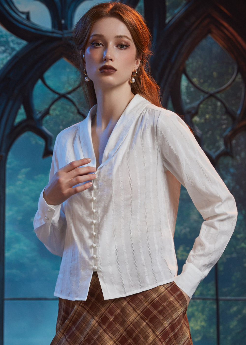 Woman wearing Vintage Ivory blouse with pearl-style buttons and flyaway front hem, styled with brown plaid skirt