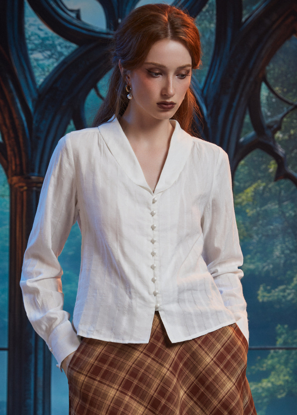 Woman wearing Vintage Ivory pearl button blouse, front view showing long sleeves, shawl collar and flyaway hem