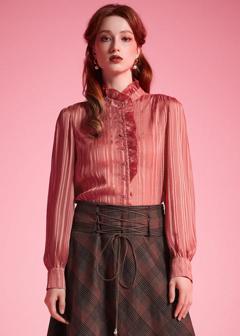 Front view of woman wearing dusty rose striped blouse with high ruffle neck, button placket, and long blouson sleeves