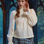 Woman wearing textured cotton-blend poet blouse with pintucked front, smocked neckline and long ruffle-cuff sleeves