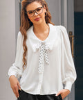 Woman wearing Petal Picnic ivory blouse with oversized collar, polka dot necktie and long blouson sleeves
