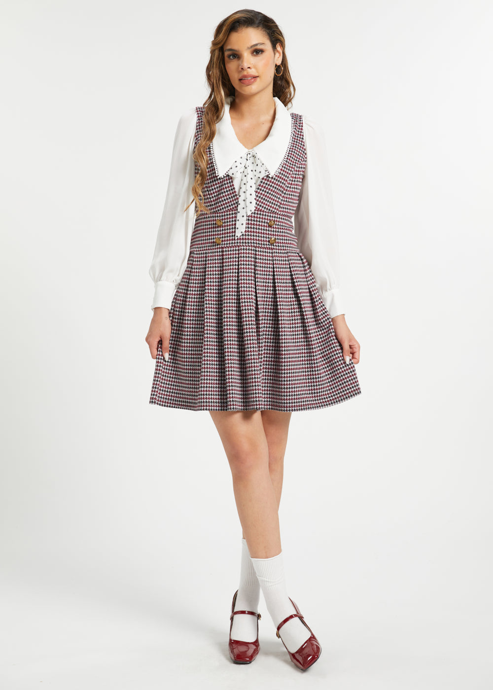 Full-length view of woman wearing vintage houndstooth jumper dress by ModCloth