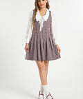 Full-length view of woman wearing vintage houndstooth jumper dress by ModCloth