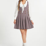 Full-length view of woman wearing vintage houndstooth jumper dress by ModCloth