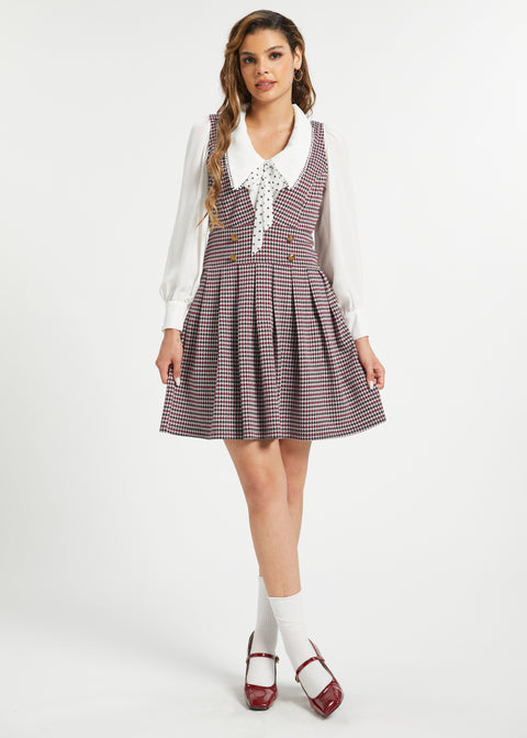 Full-length view of woman wearing vintage houndstooth jumper dress by ModCloth
