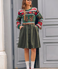 Woman wearing vintage-inspired olive corduroy skirt with sweater for fall