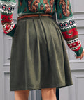 Back view of women's olive green corduroy A-line skirt with pleated silhouette