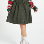 Women's olive corduroy button-front skirt styled with sweater and belt