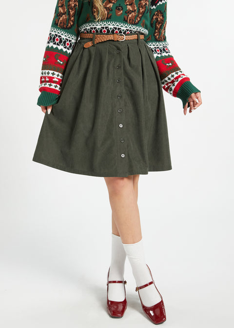 Women's olive corduroy button-front skirt styled with sweater and belt