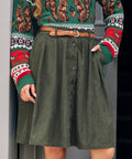 Woman wearing ModCloth olive corduroy A-line skirt with button front and pockets