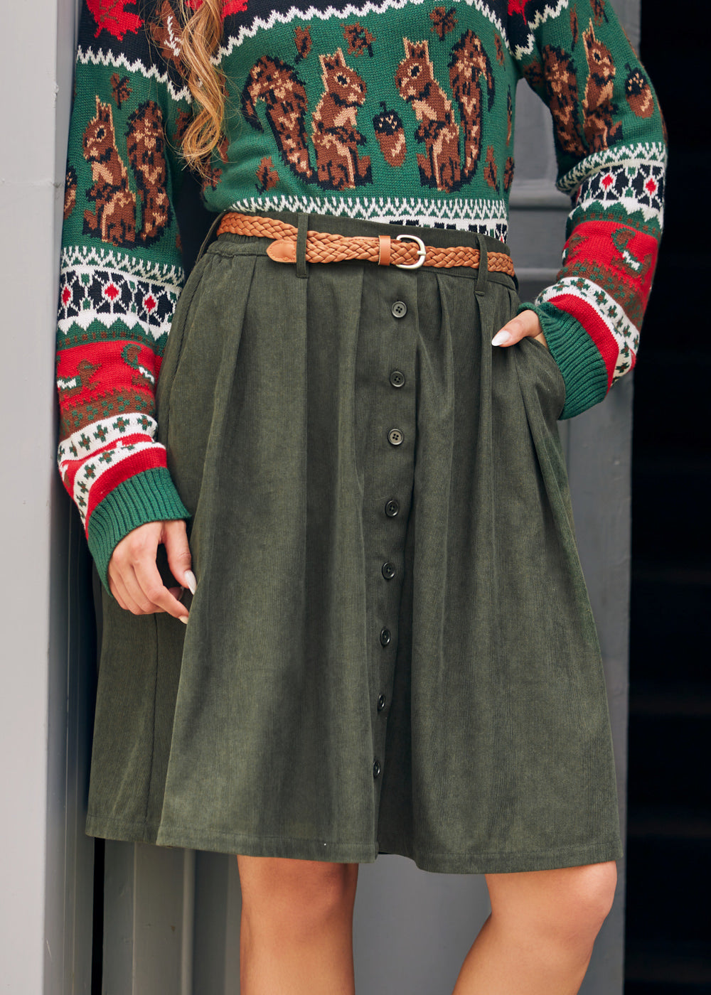 Woman wearing ModCloth olive corduroy A-line skirt with button front and pockets