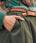 Women's olive green corduroy skirt with high waist, front pleats and buttons