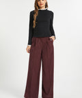 Woman wearing Mahogany Wine wide leg corduroy pants with black long sleeve top and black heels