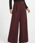 Front view of woman wearing Mahogany Wine corduroy pants showing high waist, wide legs, pleats and side pocket