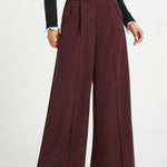 Front view of woman wearing Mahogany Wine corduroy pants showing high waist, wide legs, pleats and side pocket