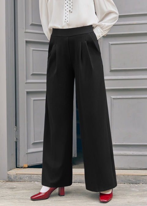 Woman wearing black wide leg pants with white vintage-inspired blouse and red heels