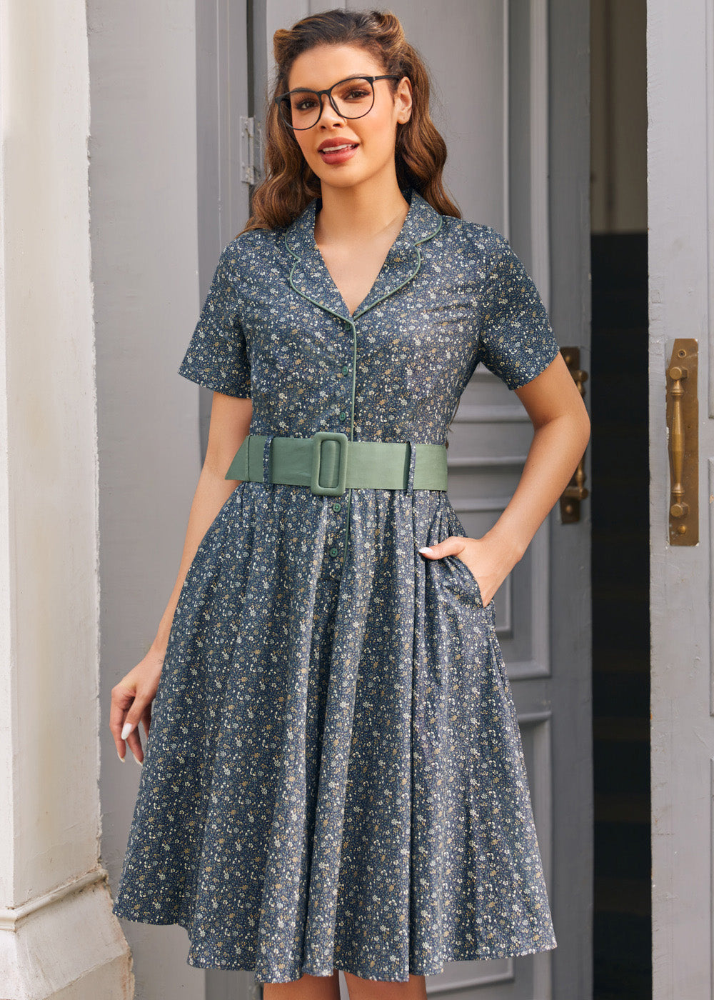 Woman wearing Rustic Elegance floral cotton shirt dress with sage belt and hand in side seam pocket