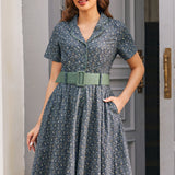 Woman wearing Rustic Elegance floral cotton shirt dress with sage belt and hand in side seam pocket