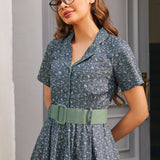 Close-up of woman wearing Rustic Elegance cotton floral dress in Forget Me Not with side pocket and sage green belt