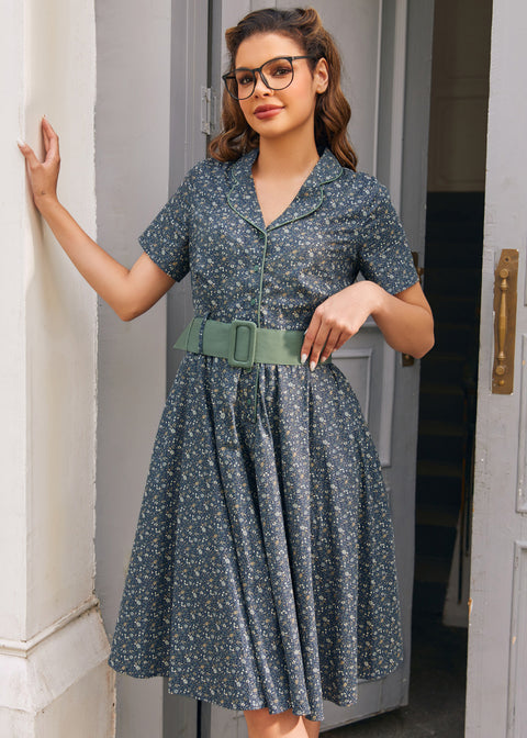 Woman wearing Rustic Elegance blue floral cotton shirt dress with sage belt, short sleeves and full fit-and-flare skirt
