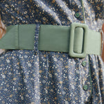 Close-up of Rustic Elegance floral cotton dress showing wide sage green belt, covered buckle, green buttons and gathered waist