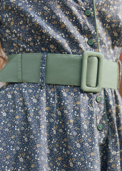 Close-up of Rustic Elegance floral cotton dress showing wide sage green belt, covered buckle, green buttons and gathered waist