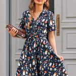Woman wearing ModCloth navy mushroom print fit and flare dress with button front, belt and pockets