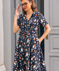 Woman wearing navy novelty mushroom print dress with short sleeves, button front bodice and side pockets