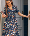 Woman wearing women's button front mushroom dress with wide belted waist and fit and flare silhouette