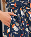Close-up of ModCloth Morel of the Story mushroom print dress with illustrated woodland fungi