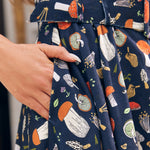 Close-up of ModCloth Morel of the Story mushroom print dress with illustrated woodland fungi
