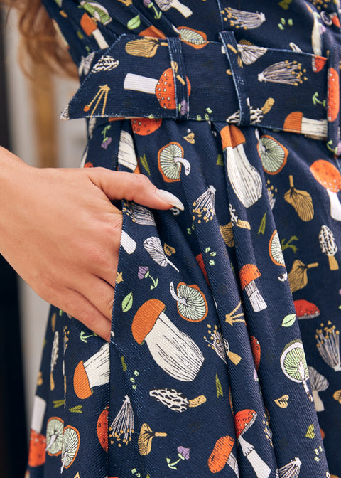 Close-up of ModCloth Morel of the Story mushroom print dress with illustrated woodland fungi