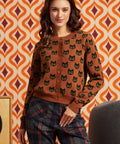 Woman wearing the Old Soul cotton cardigan with black cat motif, button front, and plaid pants, front view