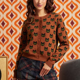 Woman wearing the Old Soul cotton cardigan with black cat motif, button front, and plaid pants, front view