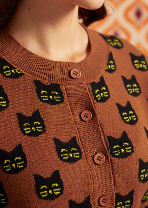 Close-up of the Old Soul cardigan showing black cat faces, crew neckline, ribbed trim, and brown buttons