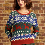 Woman wearing ModCloth's Prehistoric Parade Fair Isle Sweater with colorful dinosaur and snowflake-inspired knit motifs, front view