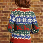 Back view of woman wearing colorful dinosaur Fair Isle sweater with repeating geometric and prehistoric motifs