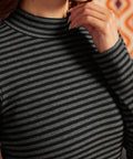 Close-up of black and heather-gray striped rib-knit top showing the mock neckline and cotton stretch fabric