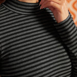 Close-up of black and heather-gray striped rib-knit top showing the mock neckline and cotton stretch fabric