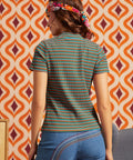 Woman wearing the Whispers of Autumn striped mock neck top with blue jeans, shown from the back
