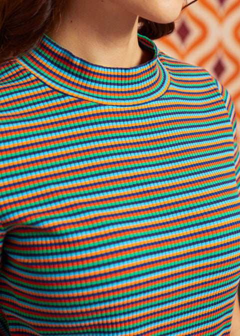 Close-up of the ribbed mock neckline and multicolor horizontal stripes on the Whispers of Autumn cotton top