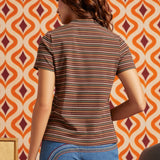 Woman wearing brown striped mock neck short sleeve top with blue jeans, back view showing fitted silhouette and horizontal stripe pattern