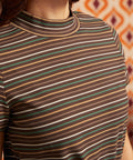 Close-up of brown ribbed mock neck top showing horizontal cream, green, camel, and rust stripes and neckline