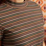 Close-up of brown ribbed mock neck top showing horizontal cream, green, camel, and rust stripes and neckline