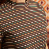 Close-up of brown ribbed mock neck top showing horizontal cream, green, camel, and rust stripes and neckline