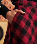 Close-up of red and black buffalo check cotton skirt showing fitted waistband and side pocket