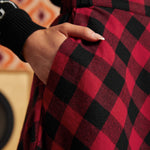 Close-up of red and black buffalo check cotton skirt showing fitted waistband and side pocket