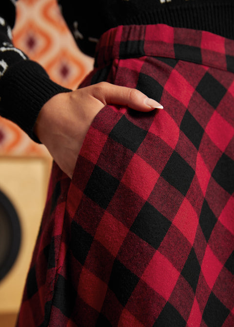 Close-up of red and black buffalo check cotton skirt showing fitted waistband and side pocket
