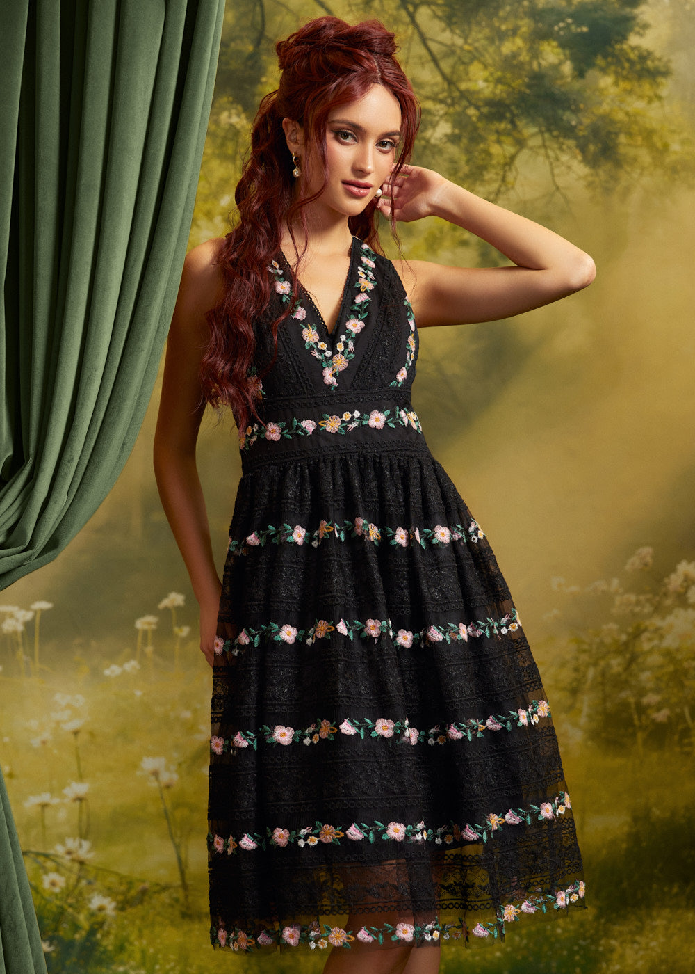 Front view of a black floral embroidered lace dress featuring a deep V-neckline, defined waist, and full fit-and-flare skirt with pink, yellow, and green floral accents.